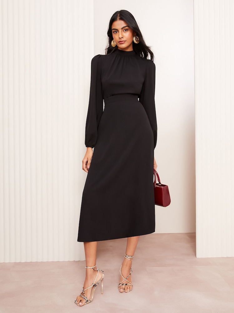 Illustrative example of black midi dress with sleeves