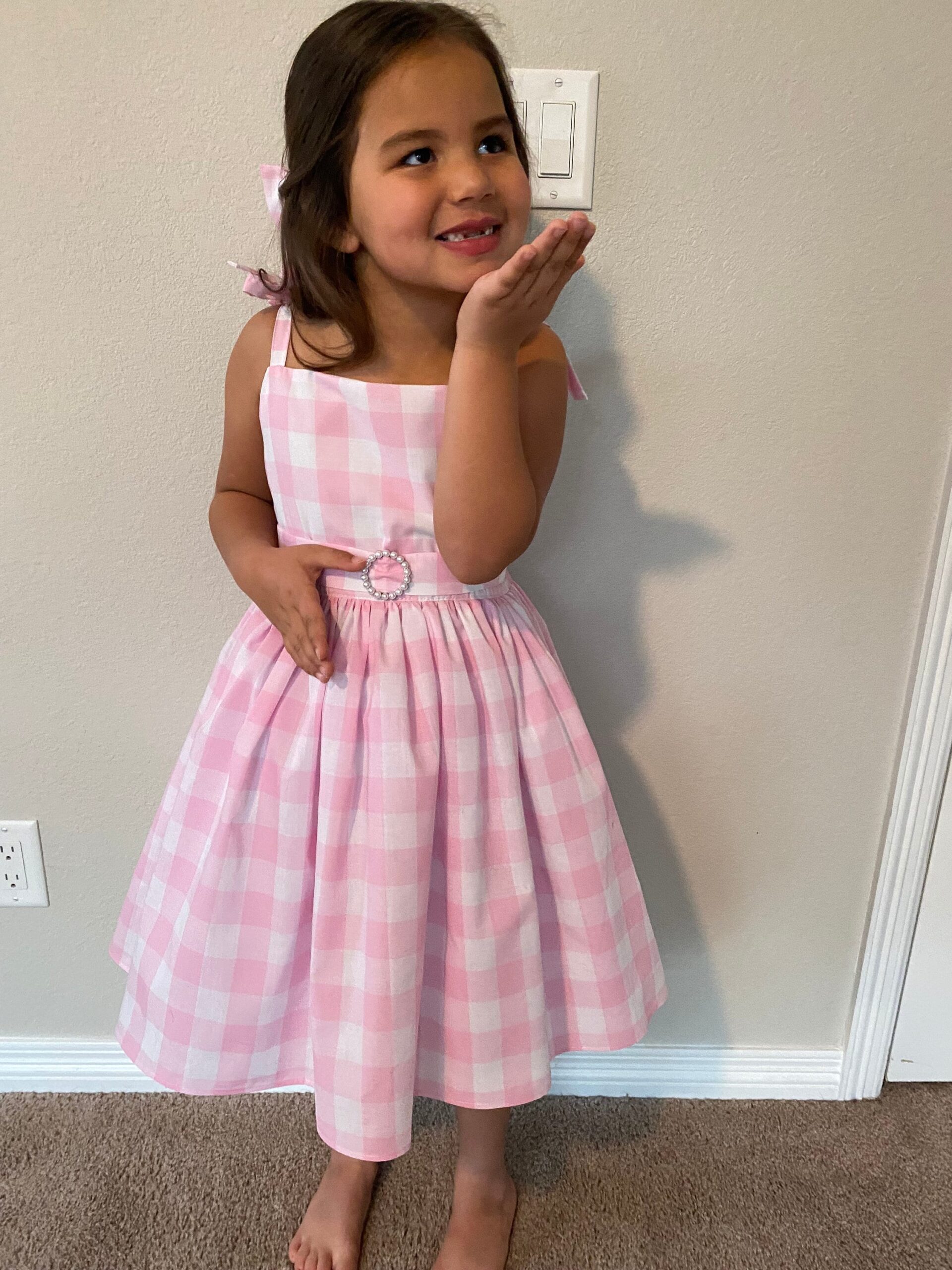 Illustrative example of pink gingham dress